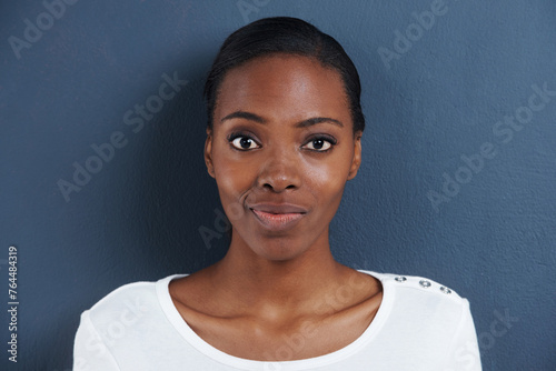 Black woman, portrait and doubt in studio with confused, thinking and unsure of planning. African model, question or smirk face with expression of whatever for decision or closeup by blue background