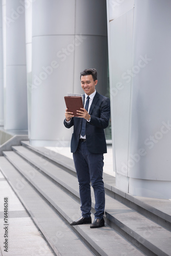 Asian Businessman reading a newspaper.