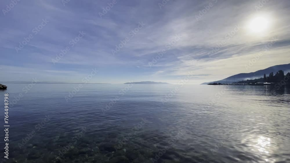 Pan over island in distance on shore, Opatija, Croatia Pan over island in distance on shore, Opatija, Croatia