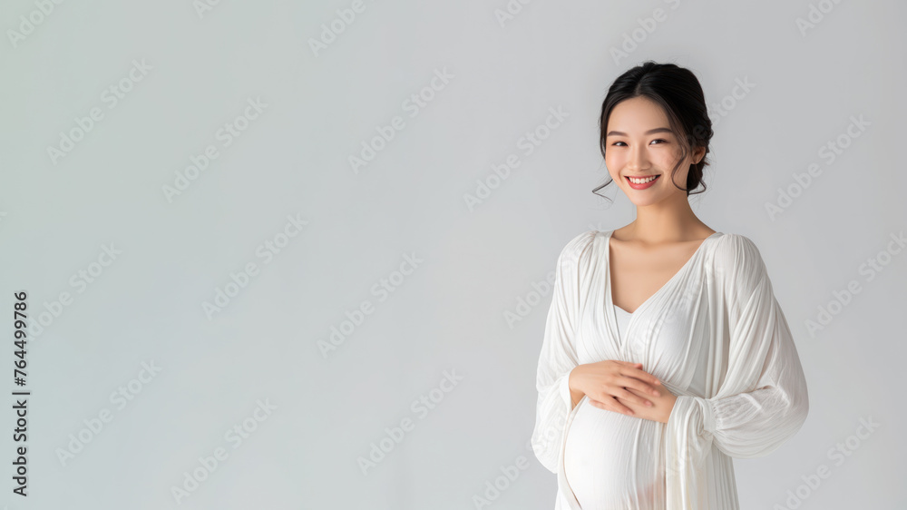 Asian pregnant woman with pregnancy belly, in soft white clothes Asian pregnant woman with pregnancy belly, in soft white clothes