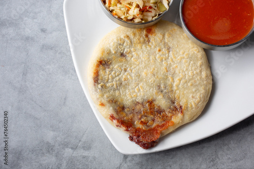 A top down view of a bean and cheese stuffed pupusas.