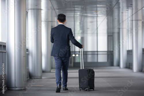 Back view of an Asian businessman walking.