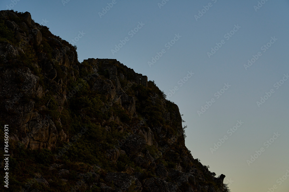 Medieval Castle Ruins of Castro Laboreiro high on a cliff in the mountains of northern Portugal inside Geras national park. Medieval Castle Ruins of Castro Laboreiro high on a cliff in the mountains of northern Portugal inside Geras national park.