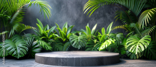 Podium Mockup. Empty circular podium with a dark, textured surface, placed in a room with grey walls and a dark tiled floor, surrounded by lush green tropical plants and leaves casting gentle shadows