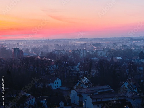 sunrise on the city, fog over the city © Piotr