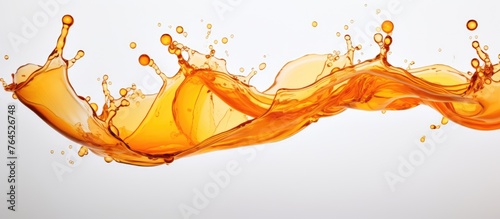 An up-close image featuring a dynamic splash of bright orange liquid