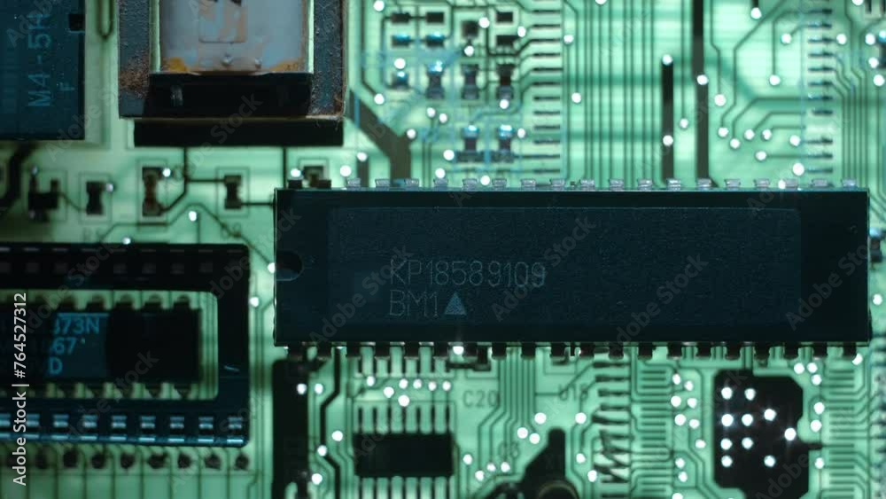 A printed circuit board with microchips whitch cast shadows that follow the light source. Closeup. Macro A printed circuit board with microchips whitch cast shadows that follow the light source. Closeup. Macro