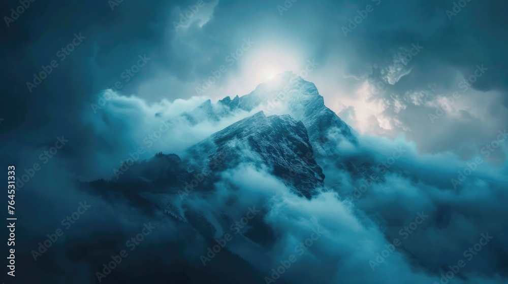 Mountain covered in clouds under a cloudy sky, suitable for nature and landscape themes