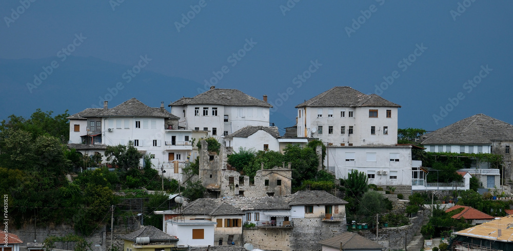Fortress in Gjirokastra a huge stone building on a high mountain in Albania with a clock the history of the Middle Ages a beautiful view from the stone city to the ancient village