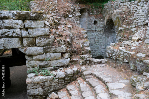 Ruins of the Great Basilica in Butrint National Park, Buthrotum, Albania. Triconch Palace at Butrint Life and death of an ancient Roman house Historical medieval Venetian Tower surrounded photo