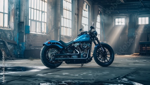 A blue Harley Davidson motorcycle with a sleek treaded tire and shiny rim is parked in a vacant building, showcasing its automotive design