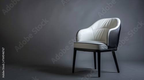 A stylish white armchair set against a grey backdrop. This piece of seating furniture exudes contemporary elegance. Radiating modern sophistication