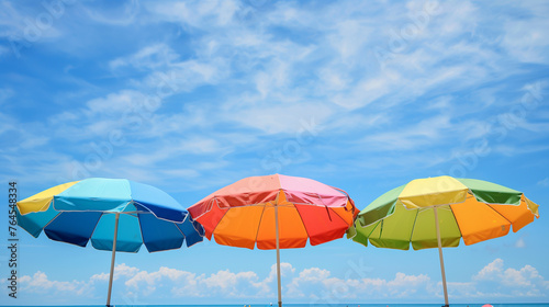 colorful beach umbrellas against a blue summer sky