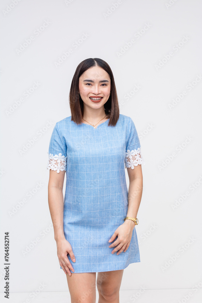 A stylish Asian woman dressed in a light blue dress isolated over a white background, exuding elegance. A stylish Asian woman dressed in a light blue dress isolated over a white background, exuding elegance.
