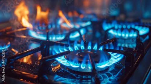 A detailed closeup shot capturing the intense blue fire emanating from a domestic kitchen stove top
