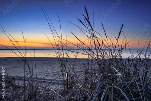 A beautiful sunset on the beach of the Sobieszewo Island at the Baltic Sea at spring. Poland © Patryk Kosmider