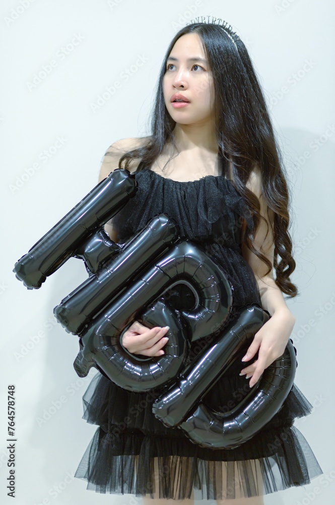 Beautiful woman wearing a black dress and chocolate cake in the concept of birthday Beautiful woman wearing a black dress and chocolate cake in the concept of birthday