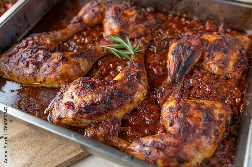 Braised chicken legs with italian red wine tomato sauce in a roasting pan Braised chicken legs with italian red wine tomato sauce in a roasting pan