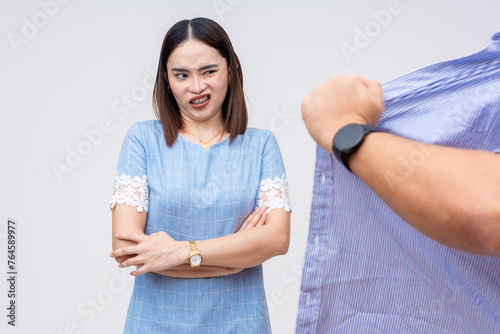 Asian woman expressing disgust and annoyance in reaction to indecent exposure, isolated on white photo