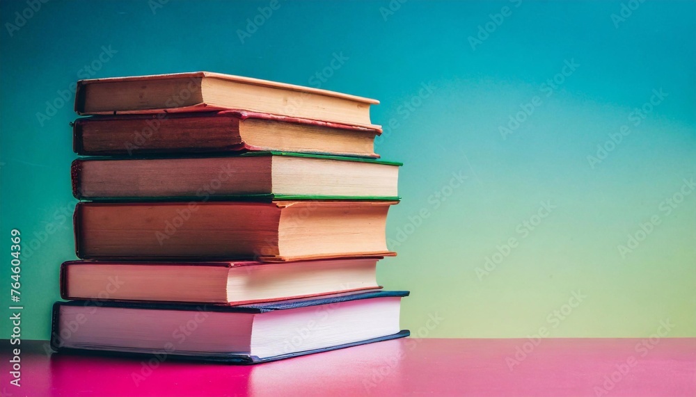 Stack of books on table colorful background and copy space