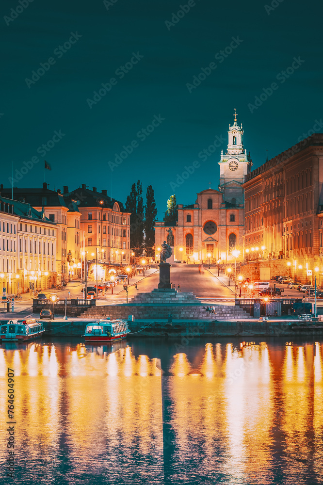 Fototapeta premium Stockholm, Sweden. Scenic Famous View Of Embankment In Old Town Of Stockholm In Night Lights. Great Church Or Church Of St. Nicholas And Royal Palace. Famous Popular Destination Scenic Place In Lights