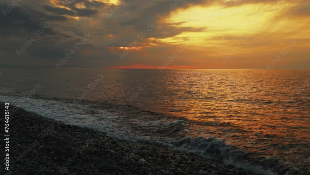 Sea rocky coast and waves against the backdrop of a cloudy sunset sky. Sea rocky coast and waves against the backdrop of a cloudy sunset sky.