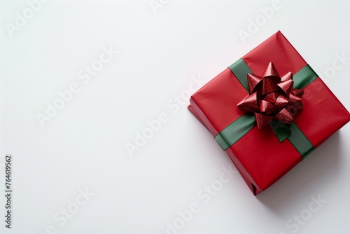 Red gift box with green ribbon and bow.