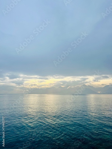 Fantastic seascape background  bright cloudy sky reflection on the blue sea surface  blue sea horizon background