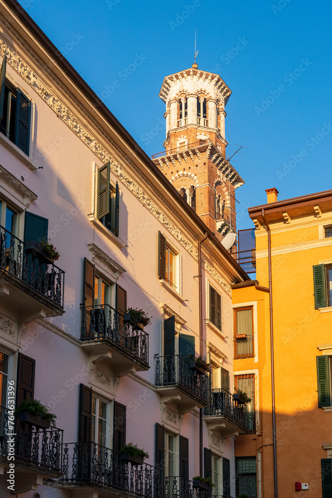 Verona city with a morning view to the church tower and traditional Italian buildings at the foreground