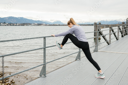 Outdoor stretching exercises by a lakeside photo
