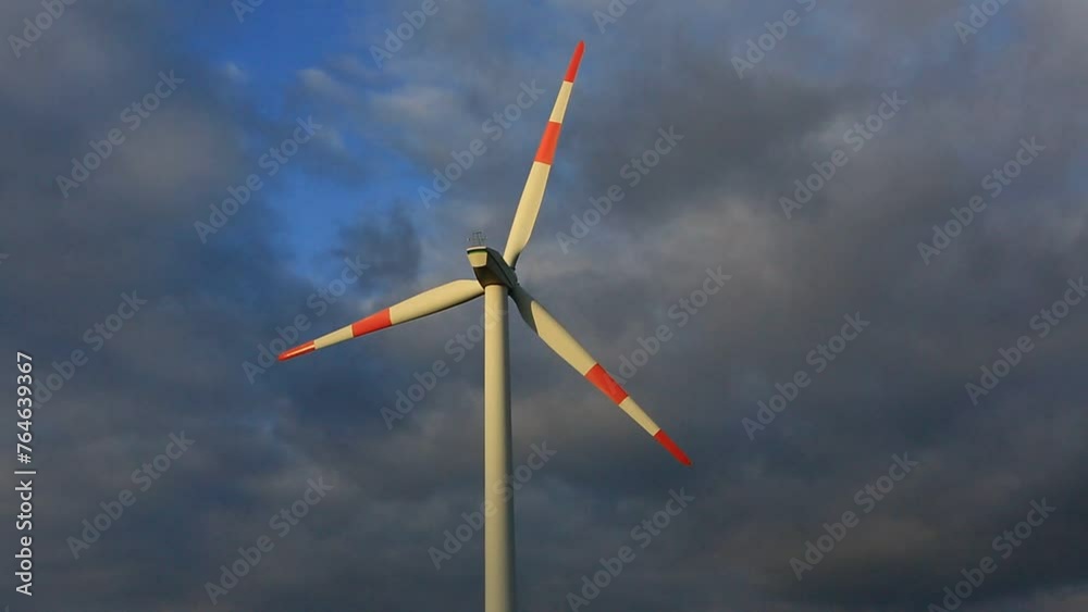 Wind turbine on the background of the blue sky. Clean renewable energy. Electric power production.