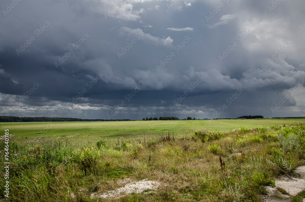 Storm clouds over a field in the summer. Russia.