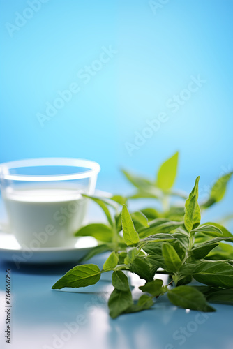 Cup of milk and bowl of basil leaves