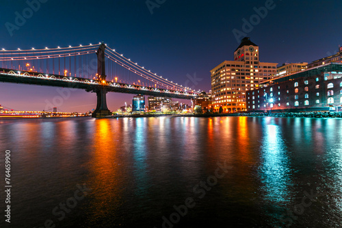  Brooklyn Bridge with lower Manhattan skyline in New York City at night  USA. Long exposure at night