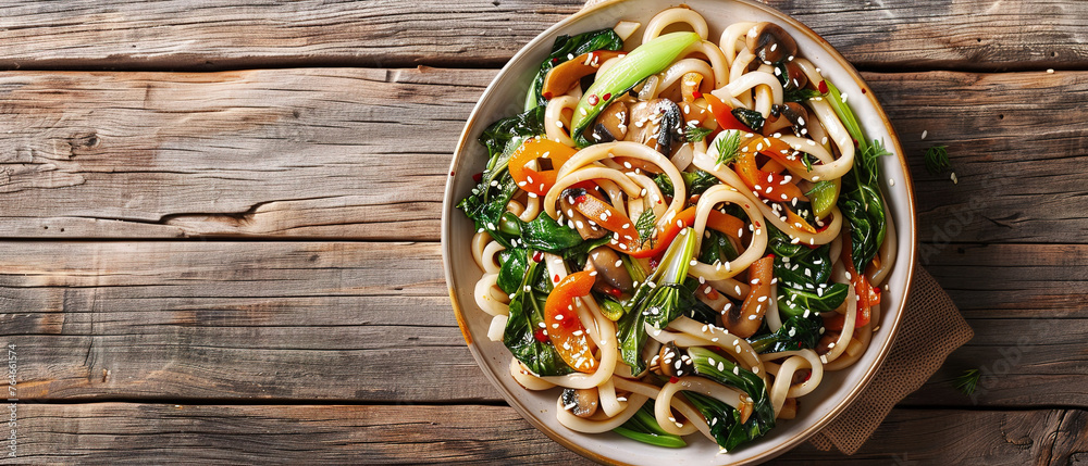 Asian vegetarian food udon noodles with baby bok choy, shiitake mushrooms, sesame and pepper close-up on a plate. horizontal top view  - obrazy, fototapety, plakaty 