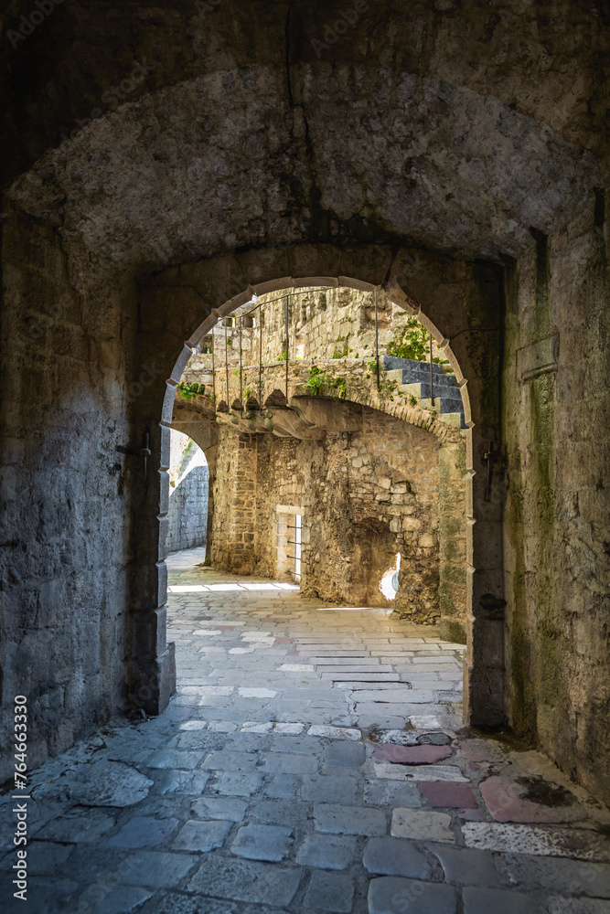 Kotor Fortress. Stone archway and cobblestone path at Gurdic Bastion, showing rich texture and historic architecture. Kotor, Montenegro