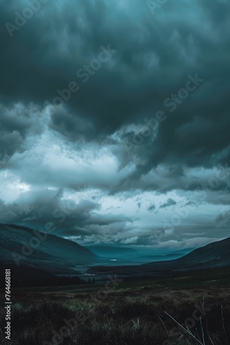 dark clouds over moody field landscape