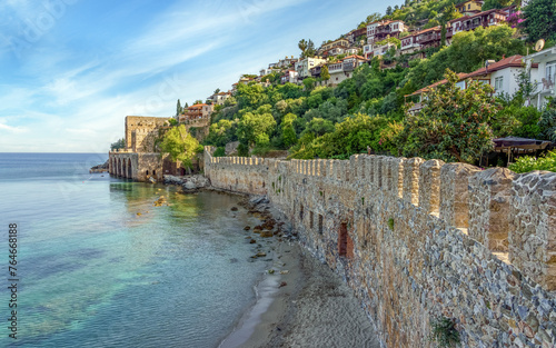 Ancient shipyard and small beach near Kizil Kule tower in Alanya, Turkey. Part of ancient old castle.