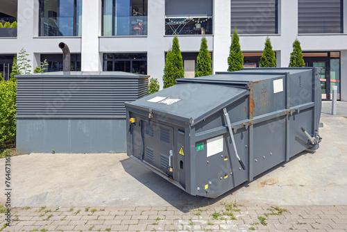 Mobile Press Container Compactor for Reducing Volume of Municipal and Industrial Waste Behind Building
