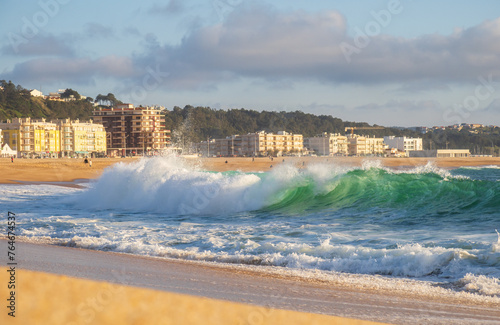 Big wave in Atlantic Ocean on the beach in Nazaré, Portugal