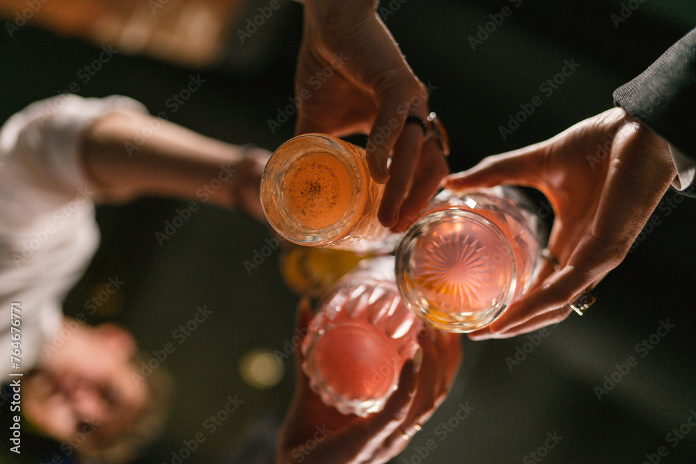 Obraz na plátně Group of friends celebrate event with alcoholic drinks in pub