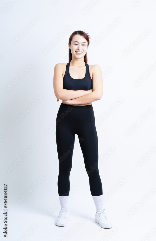 Young Asian woman wearing sportswear on white background Young Asian woman wearing sportswear on white background