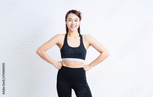 Young Asian woman wearing sportswear on white background © Timeimage