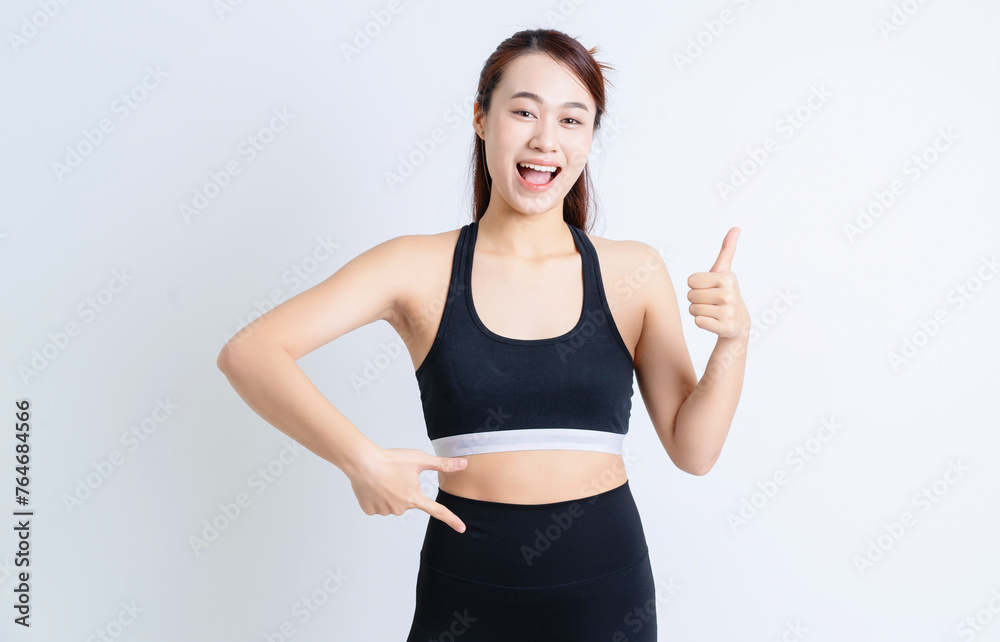 Young Asian woman wearing sportswear on white background Young Asian woman wearing sportswear on white background