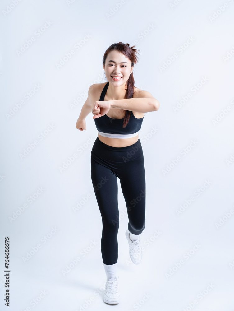Young Asian woman wearing sportswear on white background Young Asian woman wearing sportswear on white background