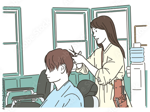 男性客の髪を切る美容師のアジア人女性