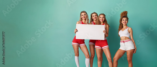 group of cheerleader holding a white placard, banner, copy space