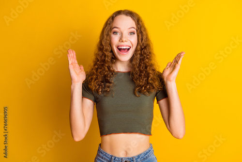 Photo of overjoyed glad girl wear trendy clothes applause celebrate luck fortune victory isolated on vivid yellow color background