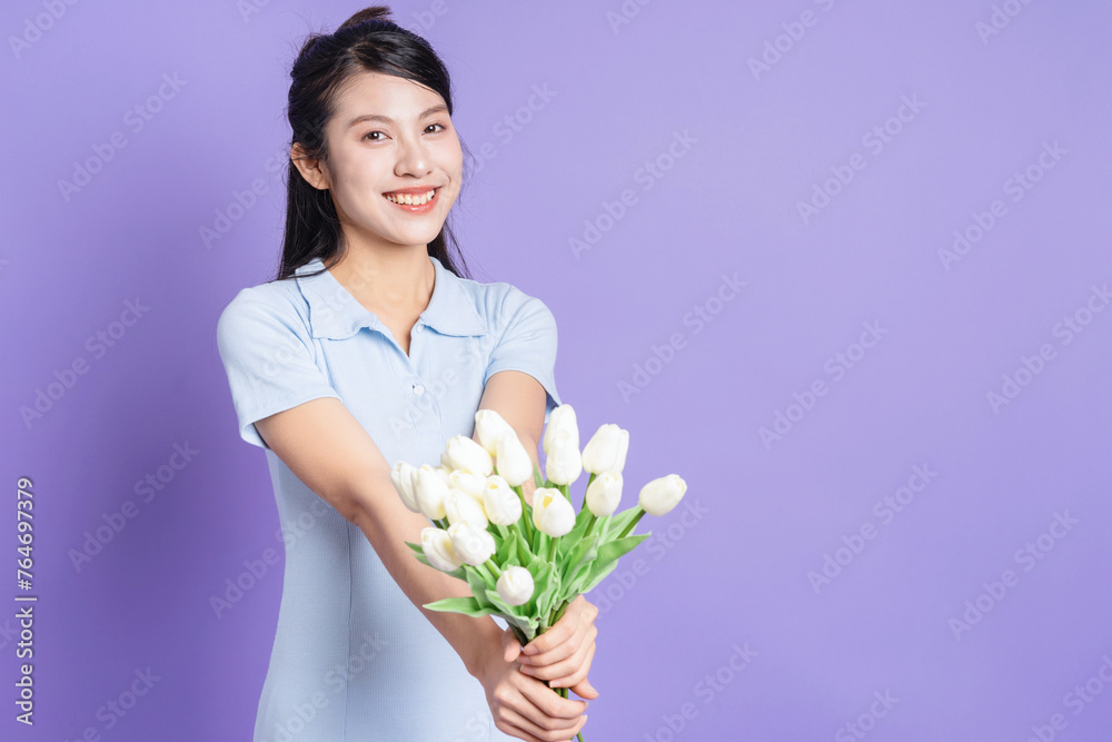 Photo of young Asian girl on purple background Photo of young Asian girl on purple background