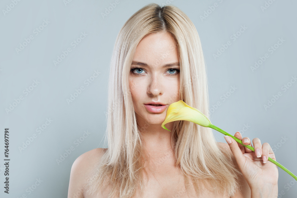 Good-looking fashion female model with long blonde hairstyle and shiny fresh skin on white background, studio portrait Good-looking fashion female model with long blonde hairstyle and shiny fresh skin on white background, studio portrait